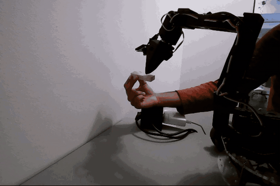the SO101 arm picking up a wooden cube, driven by molmoact2